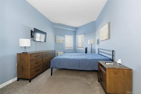 a bedroom with a bed and a night stand in it