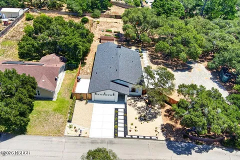 an aerial view of multiple houses with yard