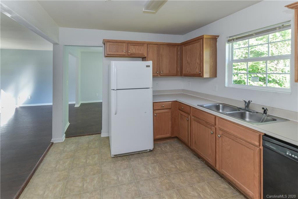3906 Harris Houston Road Charlotte, NC 28262 - Photo 11 of 28 a kitchen with a refrigerator sink and cabinets