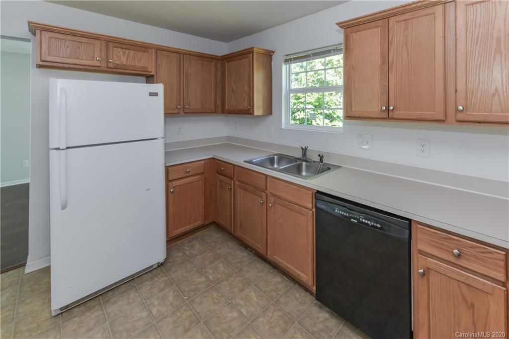 3906 Harris Houston Road Charlotte, NC 28262 - Photo 12 of 28 a kitchen with a refrigerator sink and cabinets