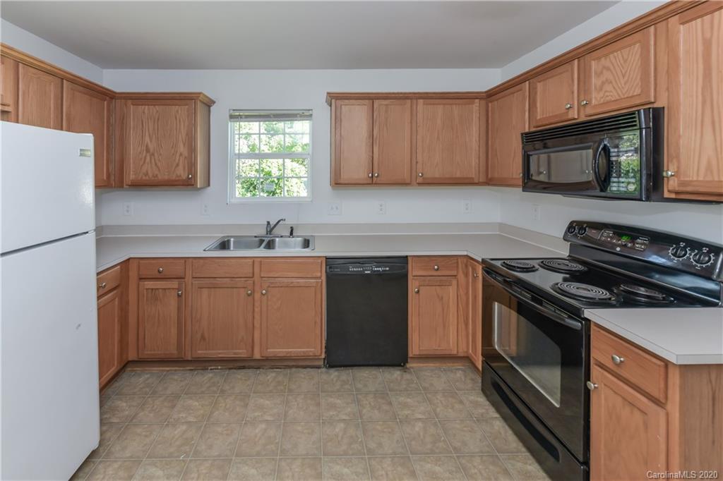 3906 Harris Houston Road Charlotte, NC 28262 - Photo 13 of 28 a kitchen with a sink stove and microwave