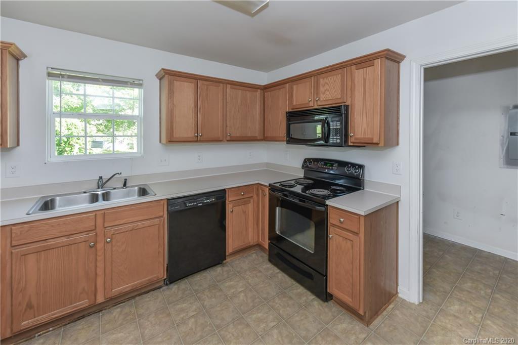 3906 Harris Houston Road Charlotte, NC 28262 - Photo 15 of 28 a kitchen with stainless steel appliances granite countertop a sink stove and microwave