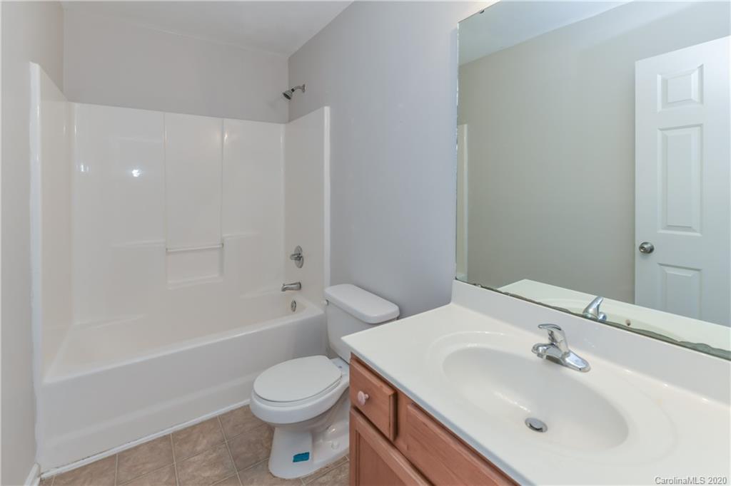 3906 Harris Houston Road Charlotte, NC 28262 - Photo 21 of 28 a bathroom with a sink toilet and a bathtub