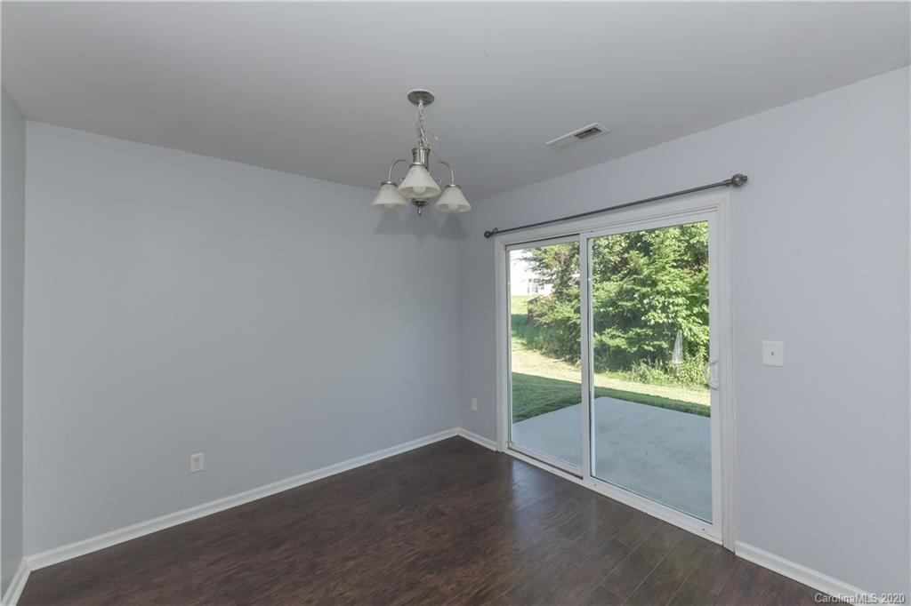 3906 Harris Houston Road Charlotte, NC 28262 - Photo 23 of 28 an empty room with wooden floor and windows