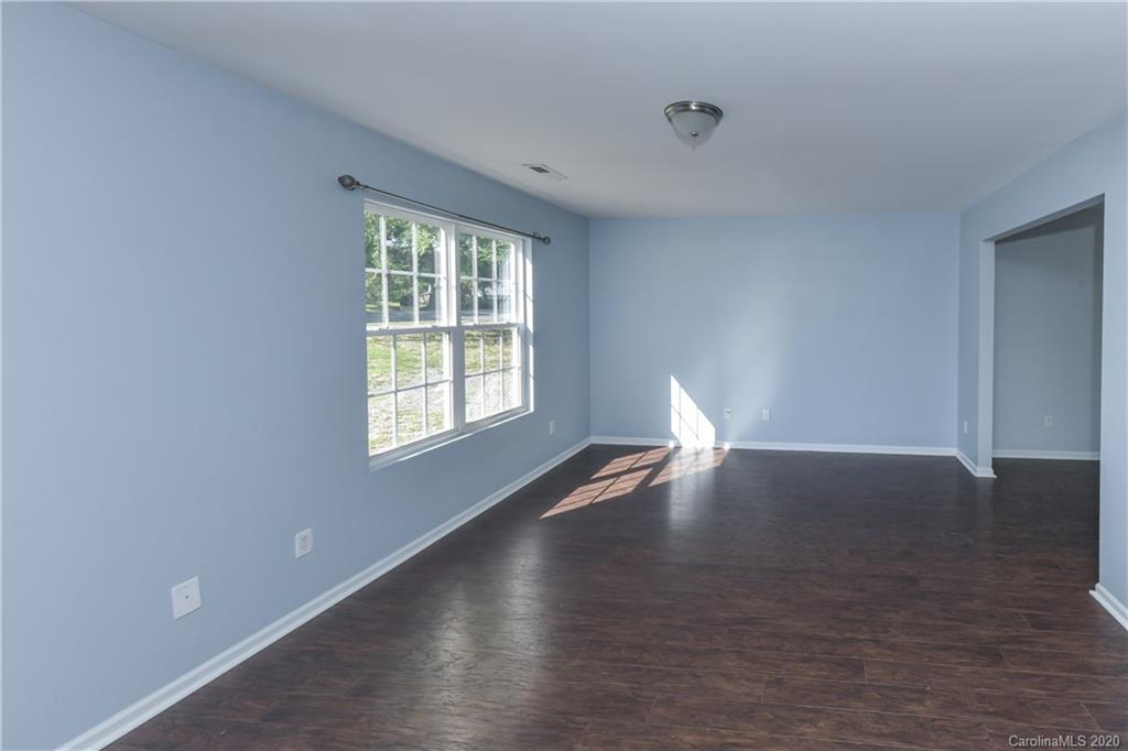 3906 Harris Houston Road Charlotte, NC 28262 - Photo 5 of 28 a view of empty room with wooden floor and fan