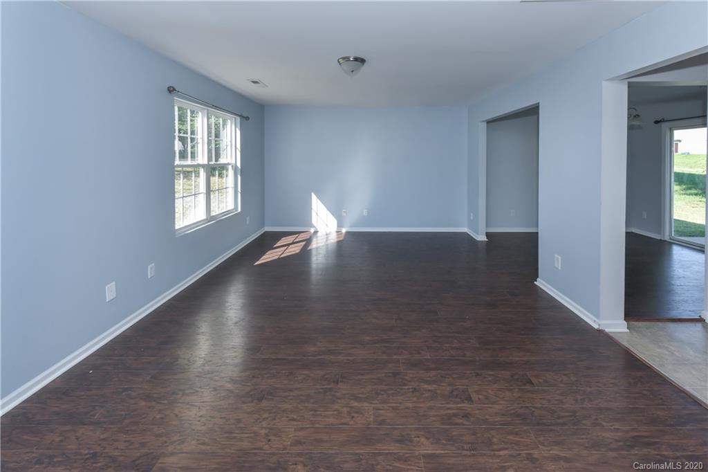 3906 Harris Houston Road Charlotte, NC 28262 - Photo 8 of 28 wooden floor in an empty room with a window
