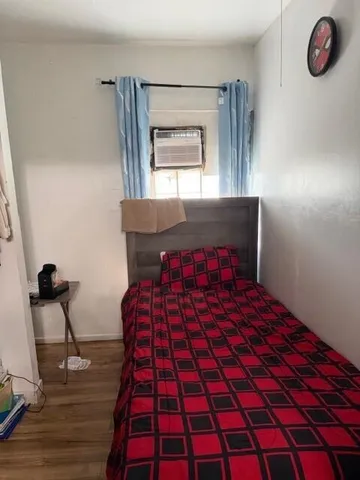 a bedroom with a bed and a window