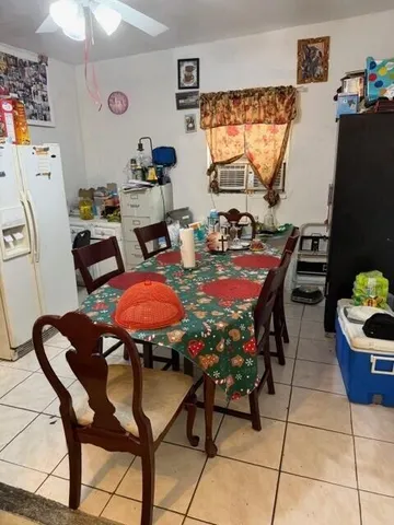 a view of a dining room with furniture and window