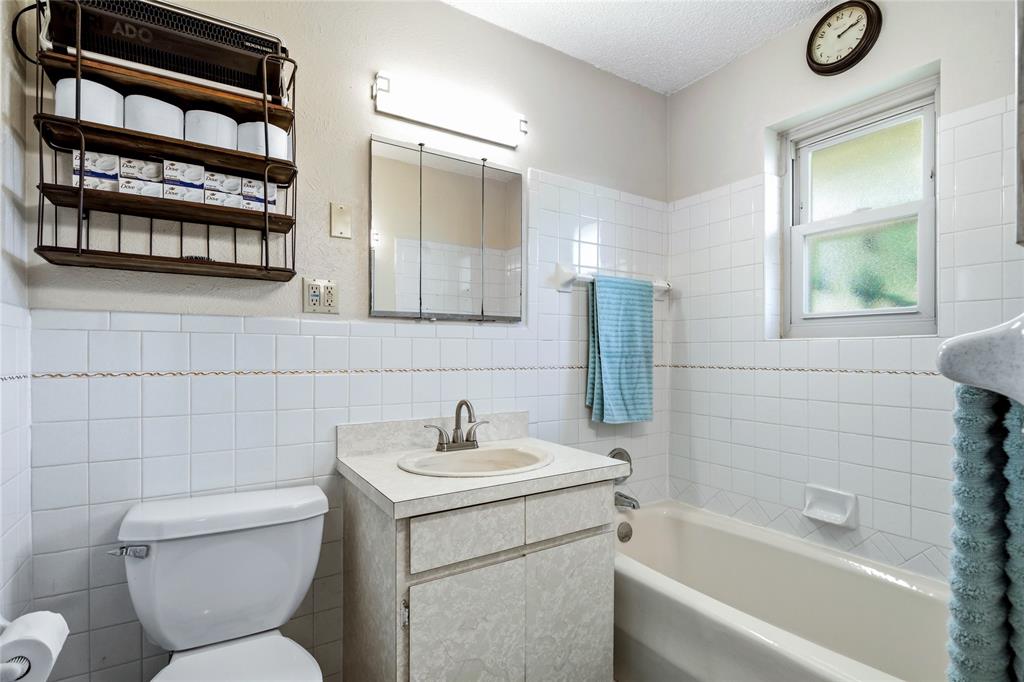 235 Magnus Road Denison, TX 75021 - Photo 19 of 35 a bathroom with a toilet sink and shower