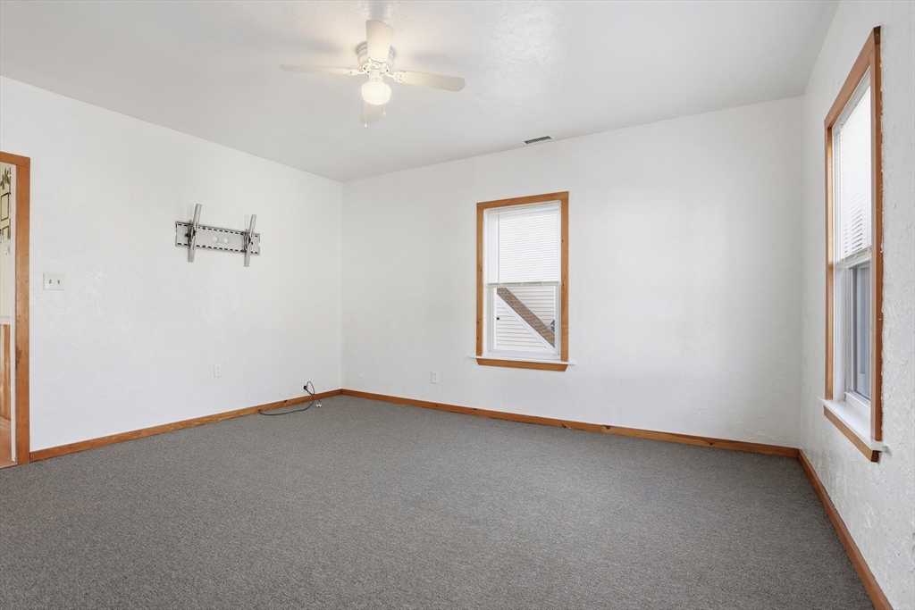 12 Whitcomb Street Webster, MA 01570 - Photo 17 of 40 an empty room with windows and fan