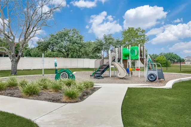 a view of a park with swings and slides