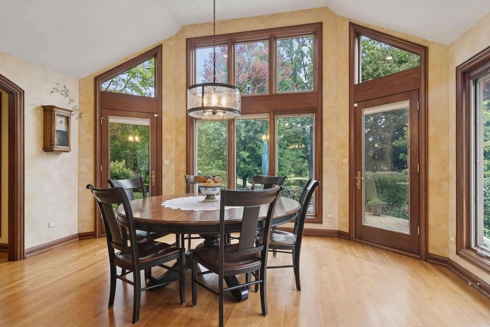 1987 Selkirk Court Inverness, IL 60010 - Photo 11 of 63 a view of a dining room with furniture large windows and wooden floor
