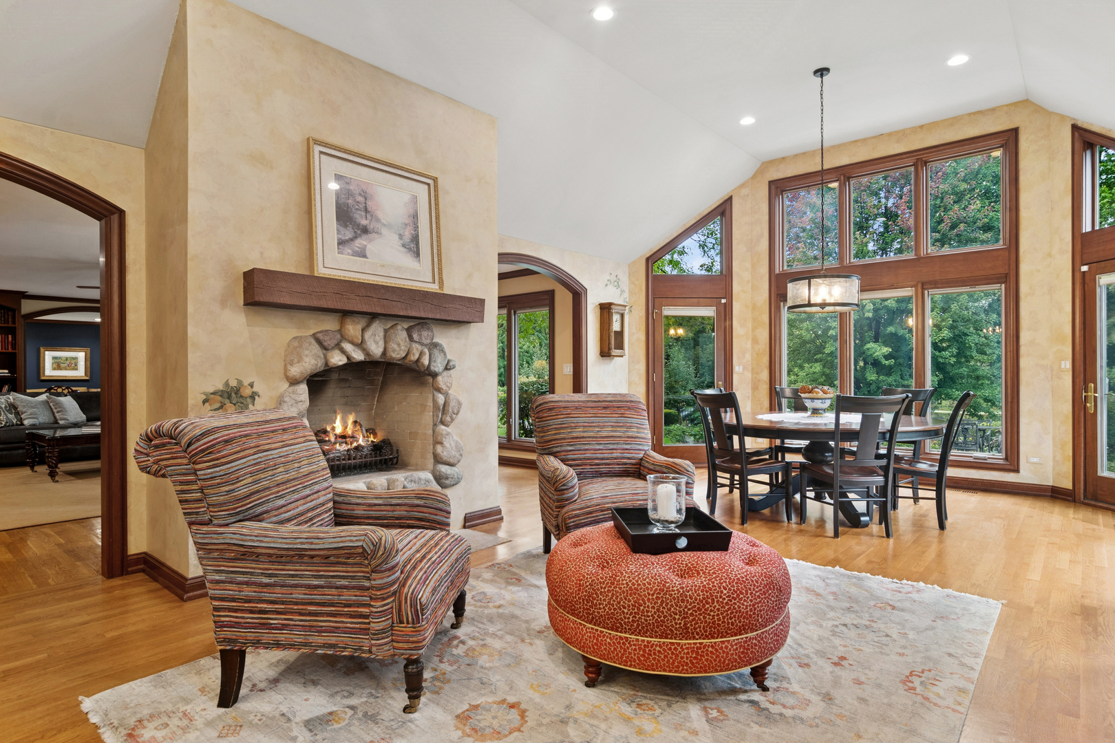 1987 Selkirk Court Inverness, IL 60010 - Photo 12 of 63 a living room with furniture a fireplace and a floor to ceiling window