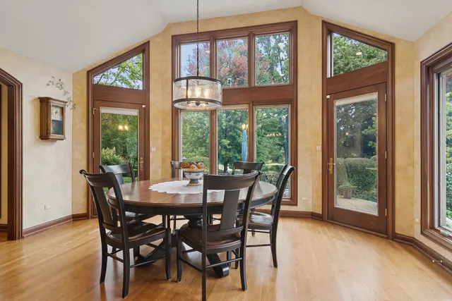 a living room with furniture a fireplace and a floor to ceiling window