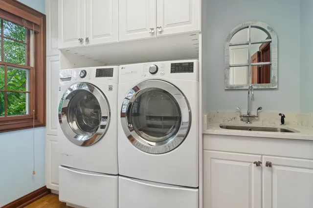 a view of a house with backyard garden and sitting area