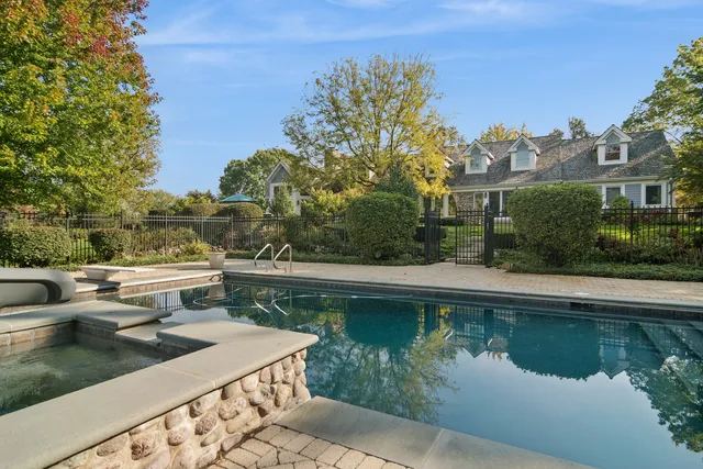 an aerial view of a house with a garden and swimming pool