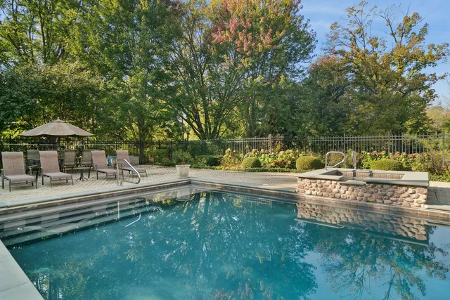 an aerial view of a house with a yard and lake view