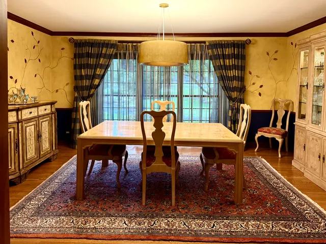 a living room with furniture a fireplace and a large window