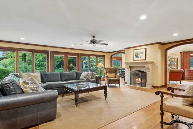 a living room with furniture ceiling fan and a fireplace