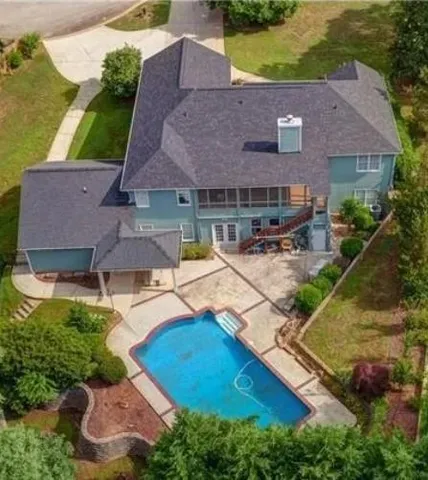 an aerial view of house with yard swimming pool and outdoor seating