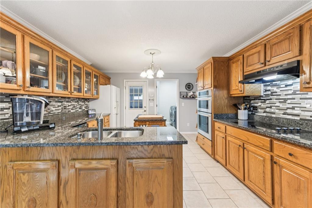 3415 South View Trail Gainesville, GA 30506 - Photo 17 of 65 a kitchen with stainless steel appliances granite countertop a sink stove and cabinets
