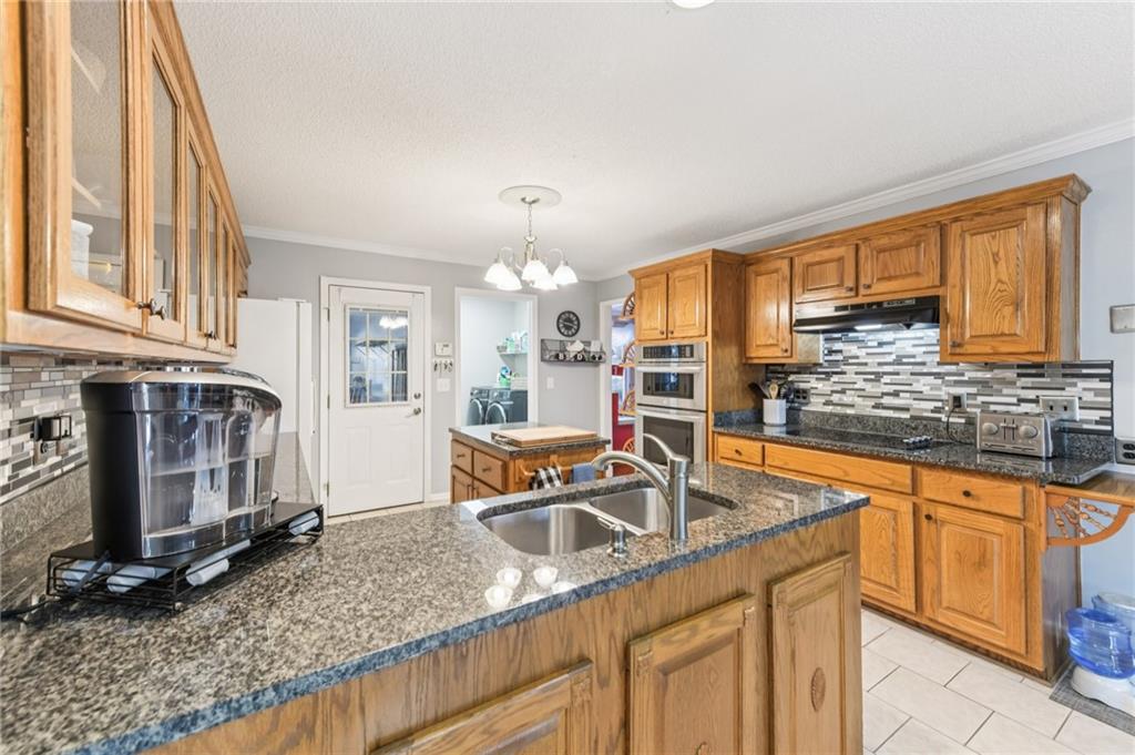 3415 South View Trail Gainesville, GA 30506 - Photo 18 of 65 a kitchen with stainless steel appliances granite countertop a sink stove and cabinets