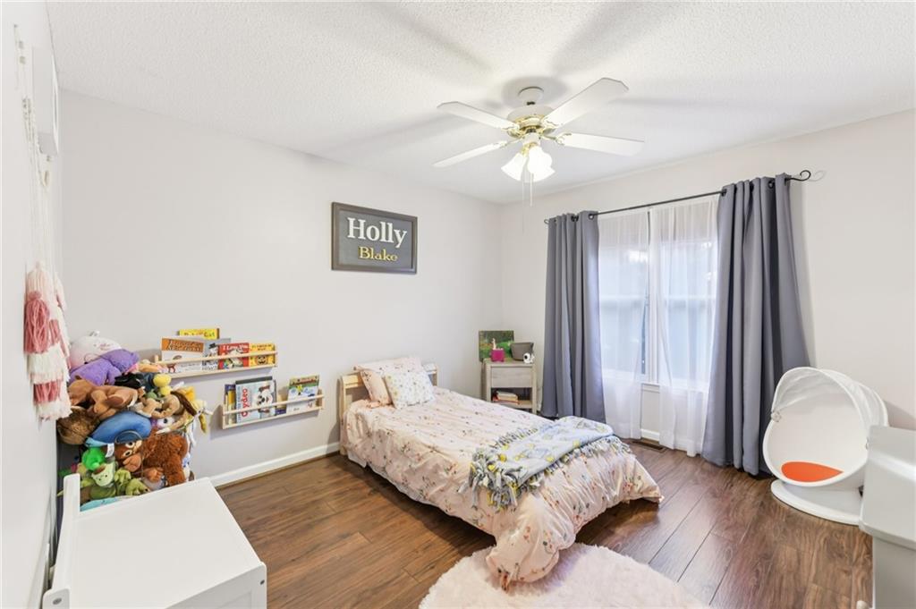 3415 South View Trail Gainesville, GA 30506 - Photo 28 of 65 a bedroom with a bed dresser and a window