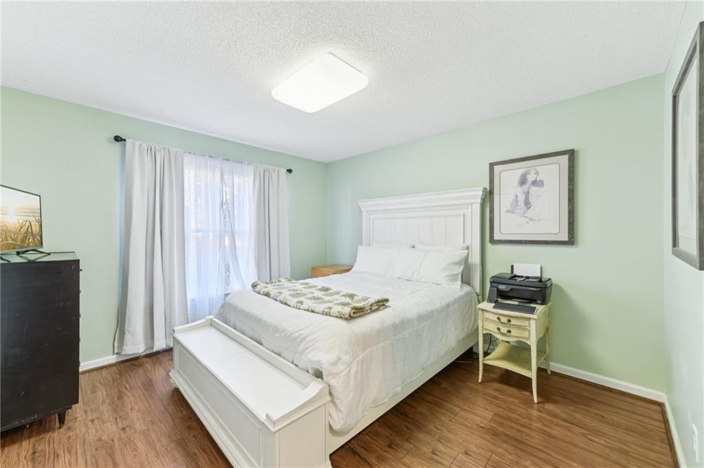 3415 South View Trail Gainesville, GA 30506 - Photo 29 of 65 a bedroom with a bed and wooden floor