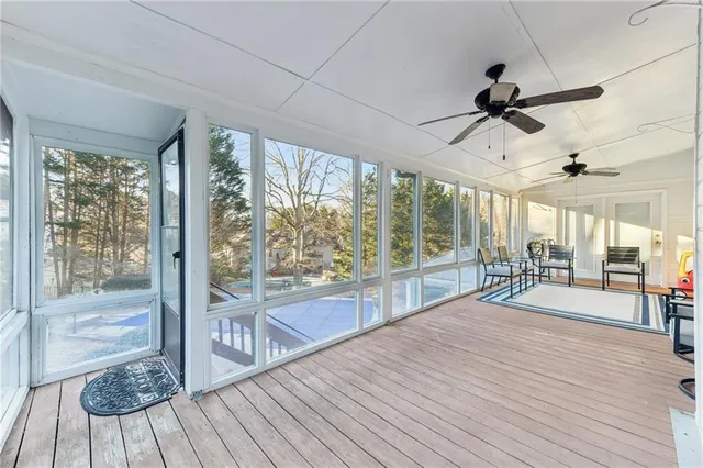 an empty room with a ceiling fan and a window