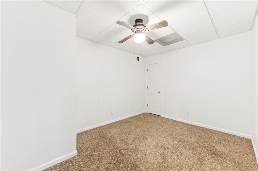 3415 South View Trail Gainesville, GA 30506 - Photo 40 of 65 an empty room with a chandelier fan and ceiling fan