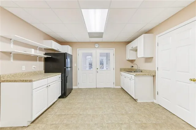 a view of a livingroom with furniture a ceiling fan wooden floor and windows
