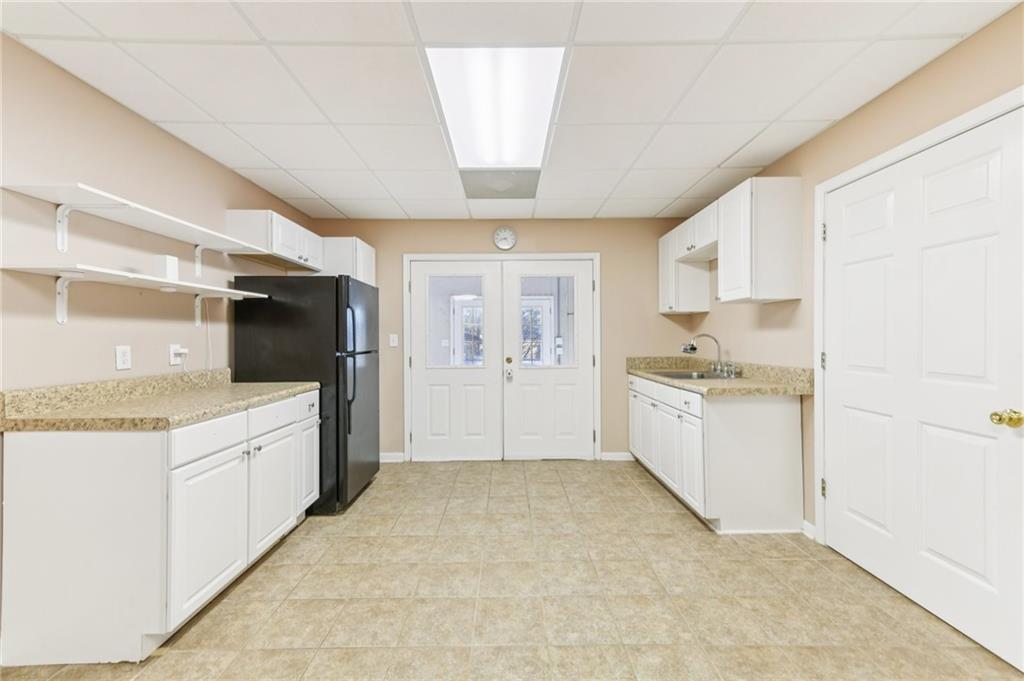 3415 South View Trail Gainesville, GA 30506 - Photo 42 of 65 a large white kitchen with granite countertop a sink and white cabinets