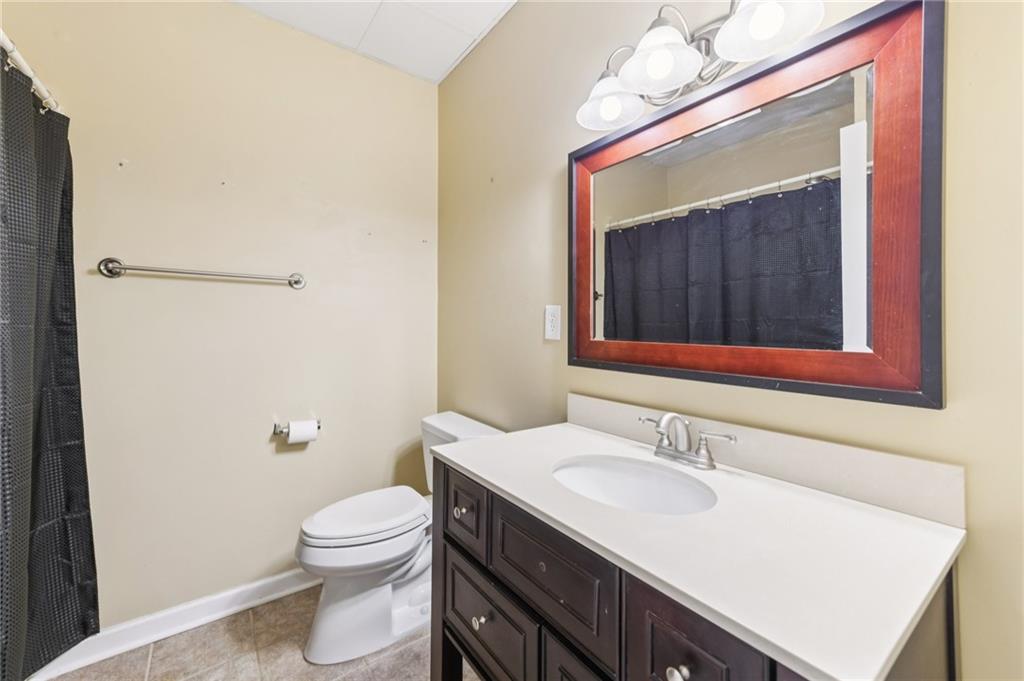 3415 South View Trail Gainesville, GA 30506 - Photo 45 of 65 a bathroom with a sink vanity granite toilet and a mirror