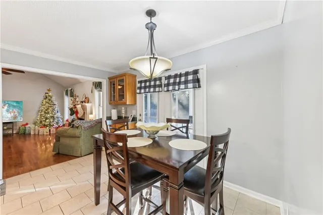 a dining room with furniture a kitchen view and wooden floor