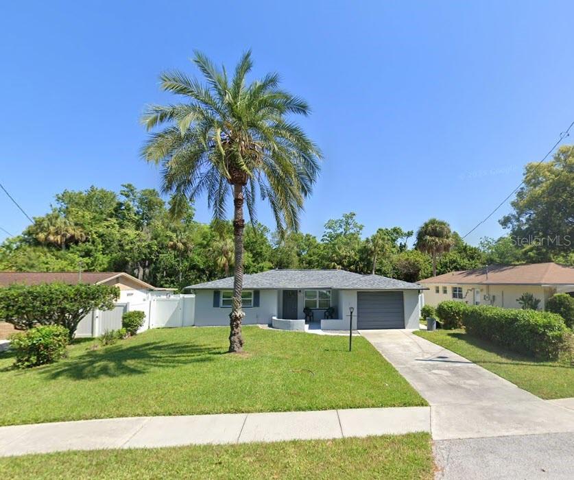 8501 Gulf Way Hudson, FL 34667 - Photo 6 of 10 a front view of a house with a yard and garage