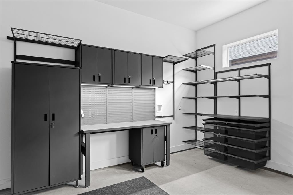 317 Rusk Street Roanoke, TX 76262 - Photo 23 of 29 Garage Custom lighted workbench, storage cabinets, drawers and shelving.