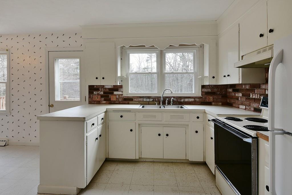 751 Fowler Road Northbridge, MA 01534 - Photo 4 of 32 a kitchen with granite countertop white cabinets and white appliances