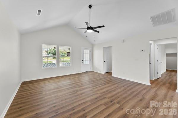 808 3rd Street Kings Mountain, NC 28086 - Photo 7 of 24 an empty room with wooden floor ceiling fan and windows