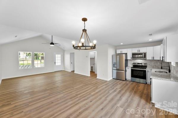808 3rd Street Kings Mountain, NC 28086 - Photo 9 of 24 a kitchen with stainless steel appliances a refrigerator sink and stove