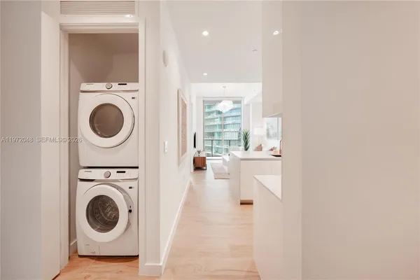 a view of a hallway with washer and dryer