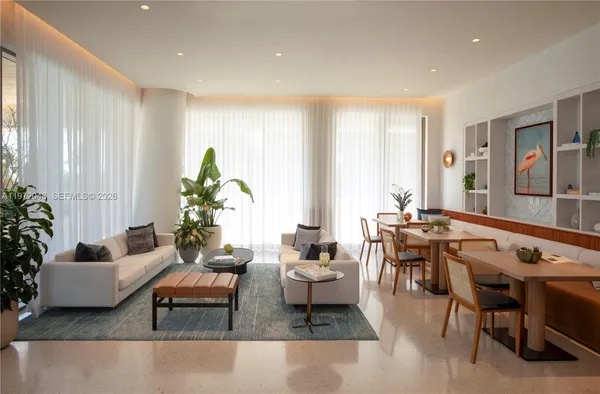a living room with furniture a rug and a window