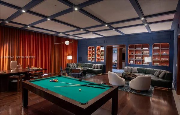 a room with furniture pool table and windows