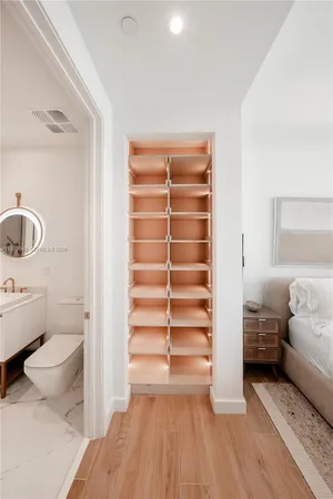 a view of walk in closet with clothes and shoes