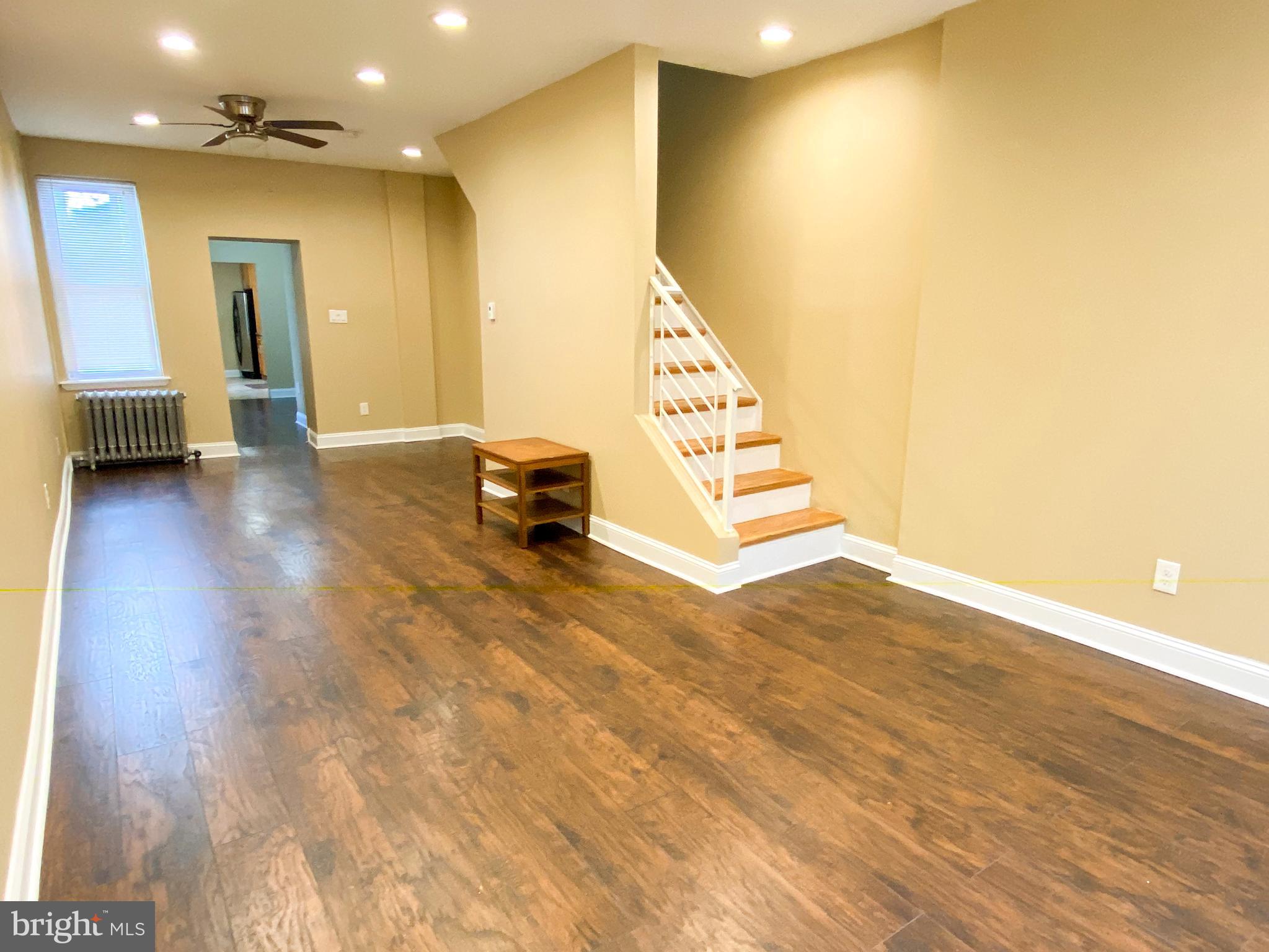 174 Master Street Philadelphia, PA 19122 - Photo 2 of 12 a view of an empty room with stairs and a living room