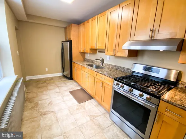 a kitchen with granite countertop a stove and a sink