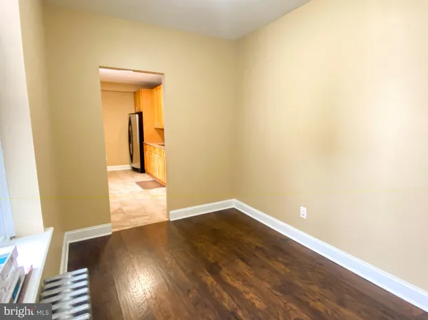 an empty room with wooden floor and a window