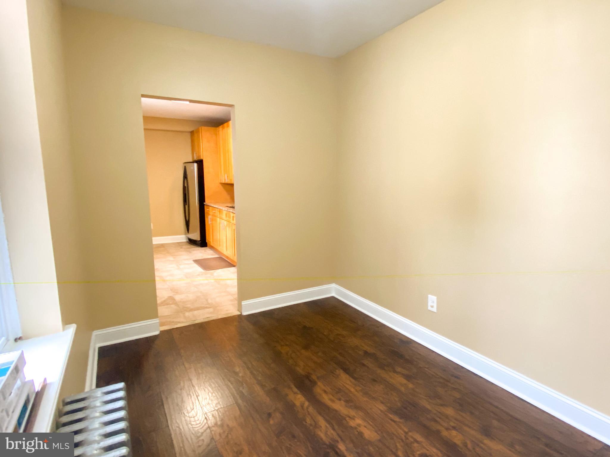 174 Master Street Philadelphia, PA 19122 - Photo 4 of 12 an empty room with wooden floor and a window
