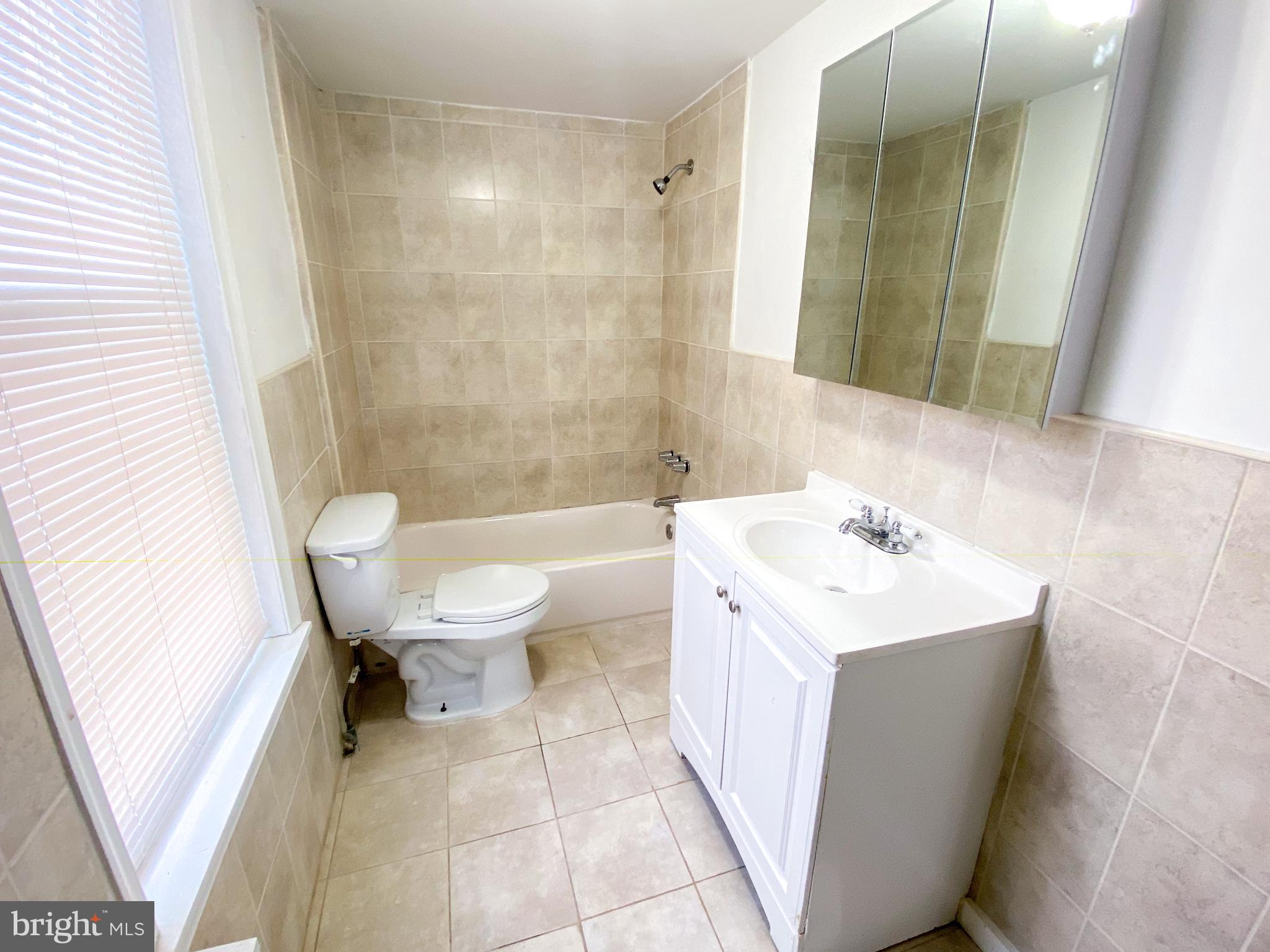 174 Master Street Philadelphia, PA 19122 - Photo 7 of 12 a bathroom with a sink a toilet and a mirror