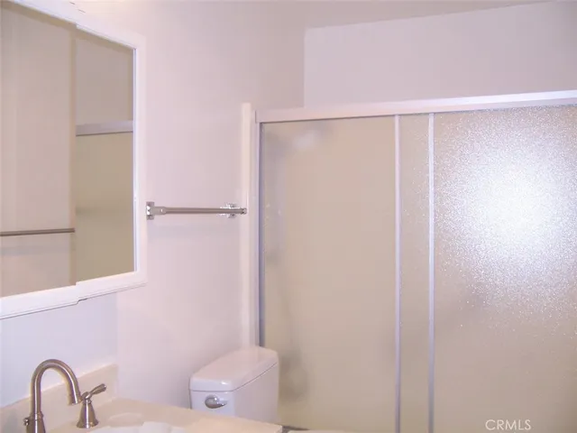a bathroom with a shower and a sink