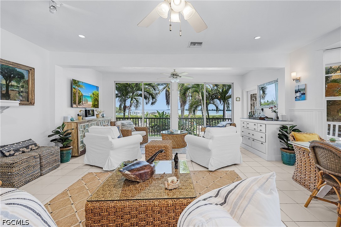 515 Useppa Useppa Island Bokeelia, FL 33922 - Photo 12 of 43 a living room with fireplace furniture and a large window